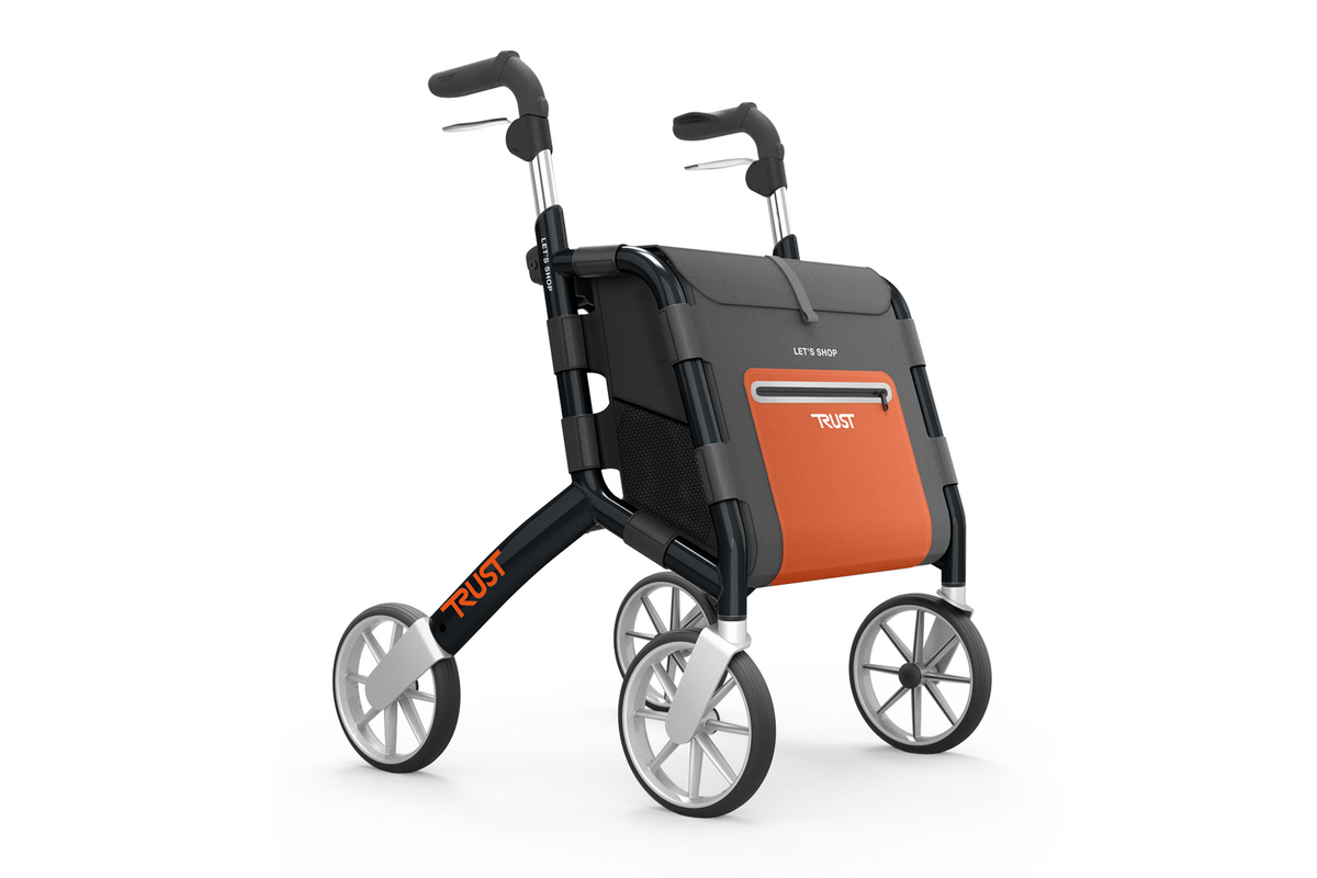 Rollator walker with black frame, orange and gray storage bag, four large wheels, and ergonomic handles on white background