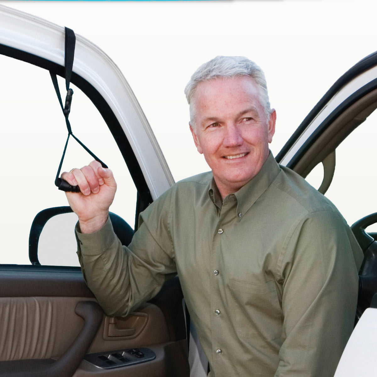 Car caddie portable handle looped over car door frame, held by smiling older man exiting vehicle