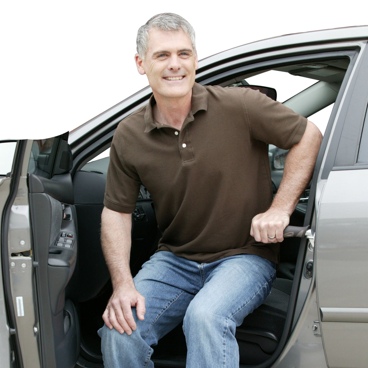 Car handle assist bar gripped by smiling middle-aged man exiting a sedan through the open driver's door