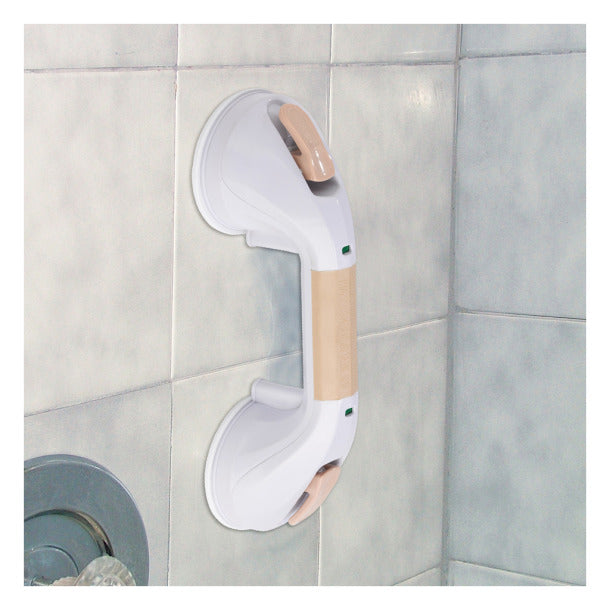 Suction cup grab bar with beige grip and green safety indicators mounted on white shower tile corner