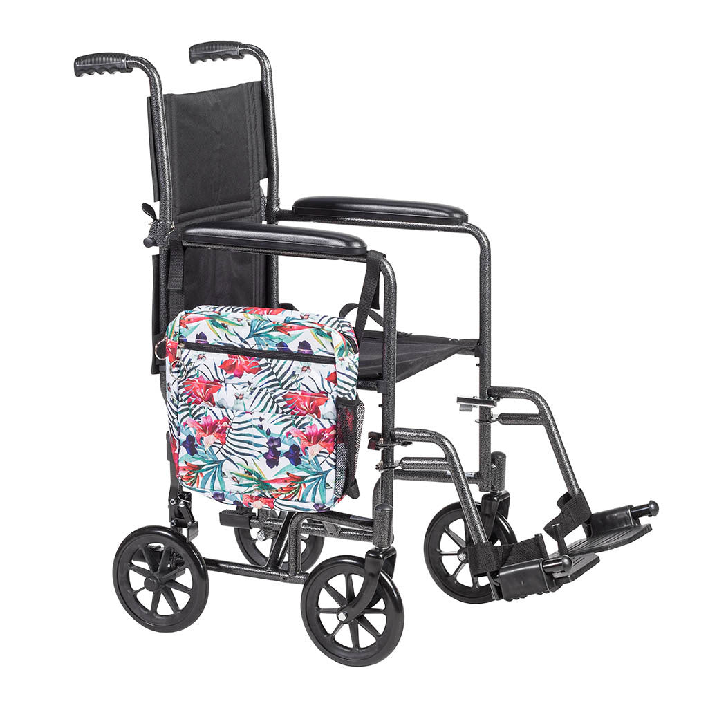 Walker tote bag with tropical floral print attached to the side of a transport wheelchair, shown against white background