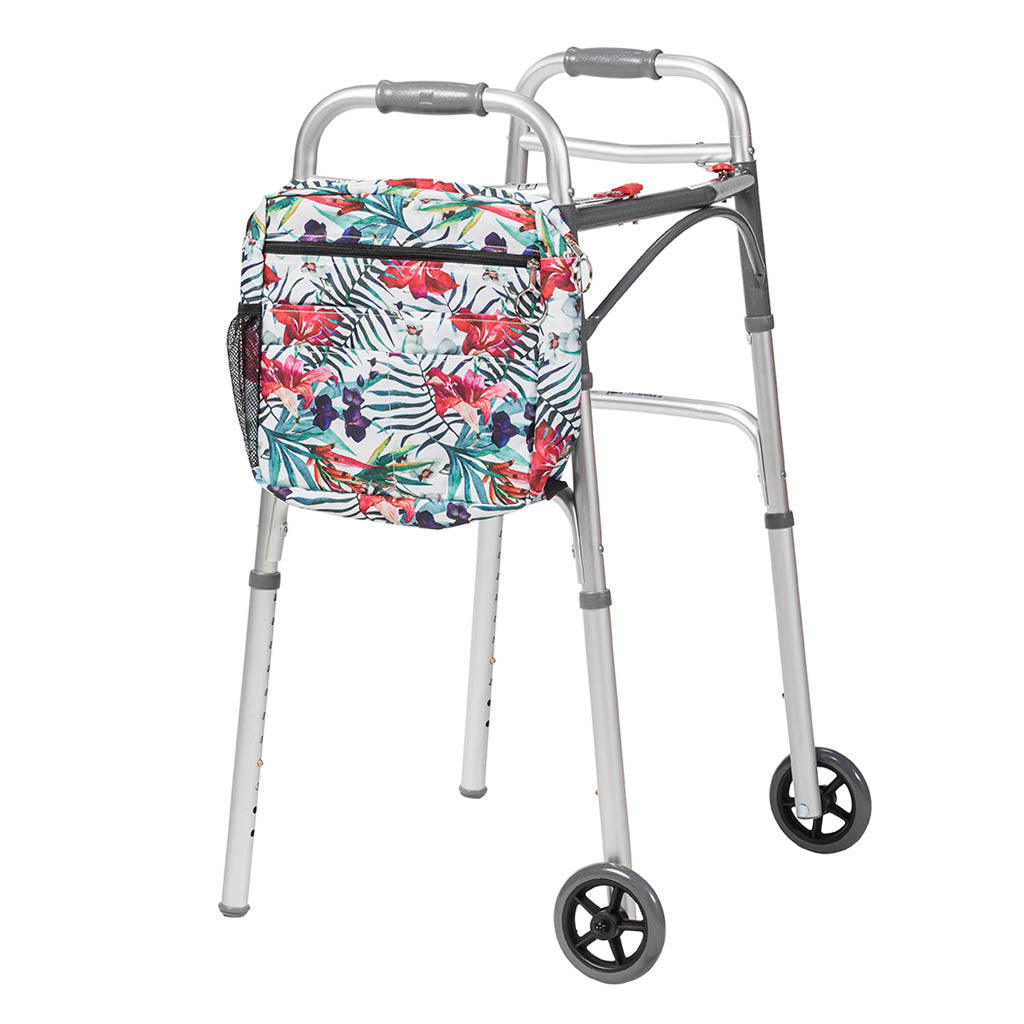 Walker tote bag with tropical floral print, zip pockets, and mesh side pocket, shown attached to a folding walker with wheels
