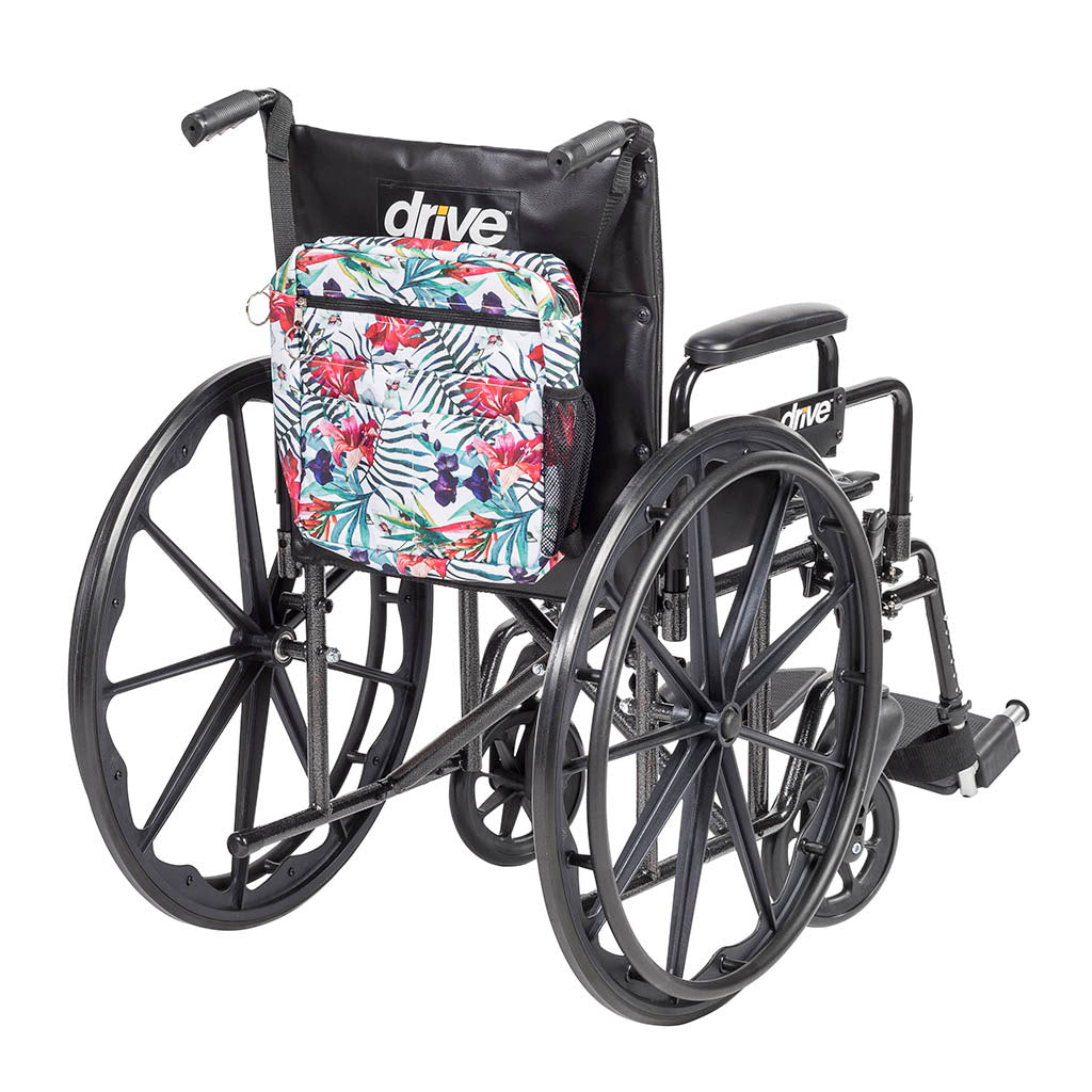 Wheelchair tote bag in tropical floral print with front zipper pocket and side mesh pocket, shown attached to a black