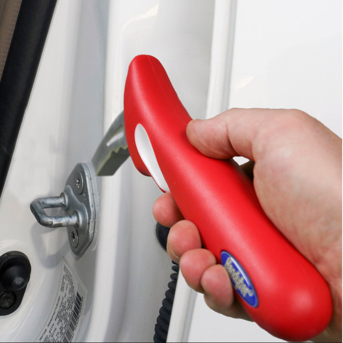 HandyBar car safety handle in red being inserted into a vehicle door latch by a hand