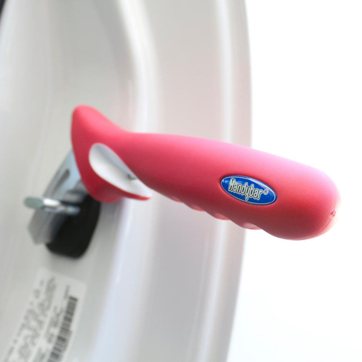 HandyBar portable car door handle support in pink, inserted into vehicle door latch striker for standing assistance