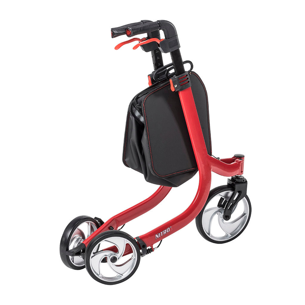 3-wheel rollator in red with black hand brakes, black storage bag, and large spoke wheels, shown folded from a side angle