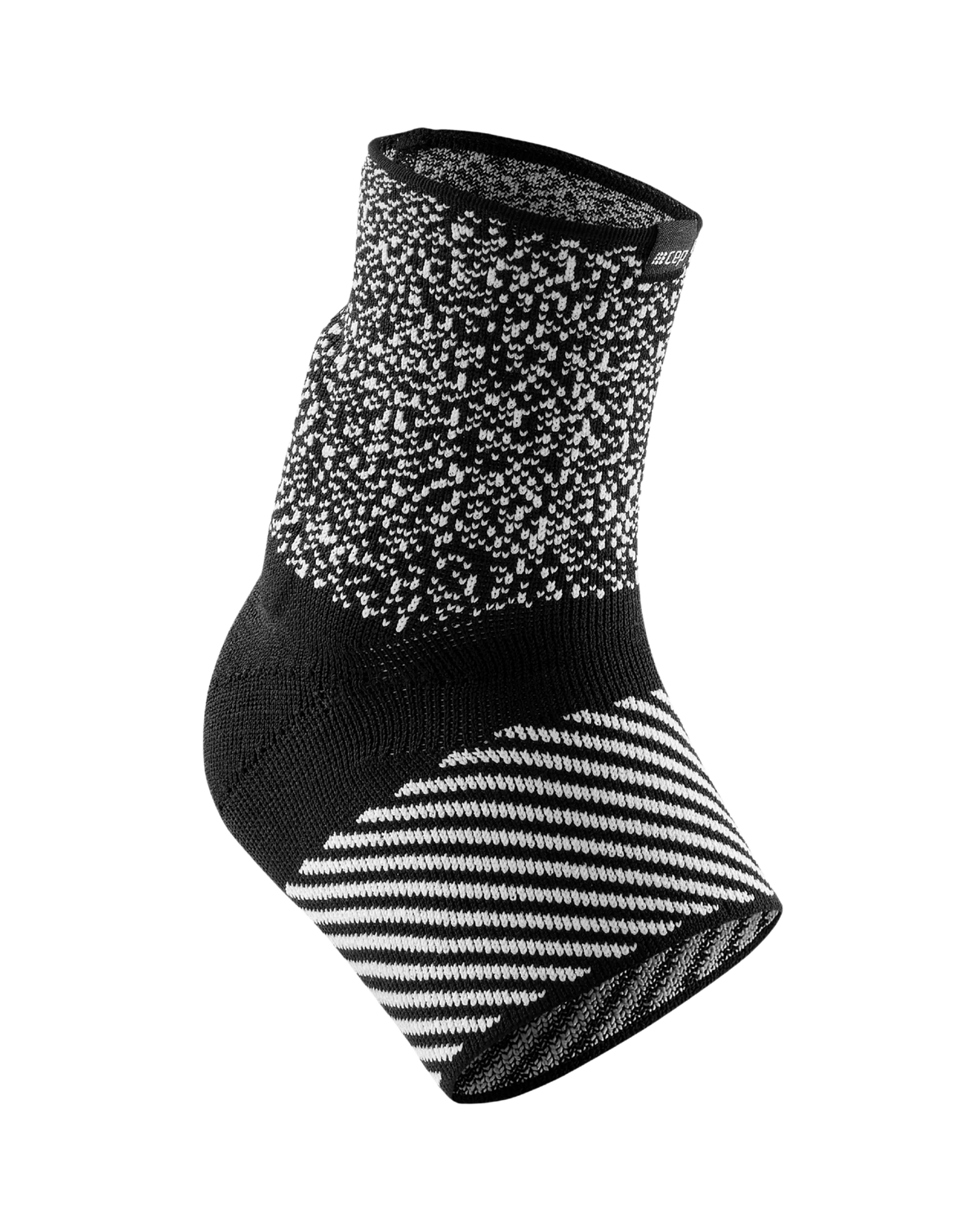 Ankle sleeve in black and white knit fabric with speckled upper and diagonal striped heel panel
