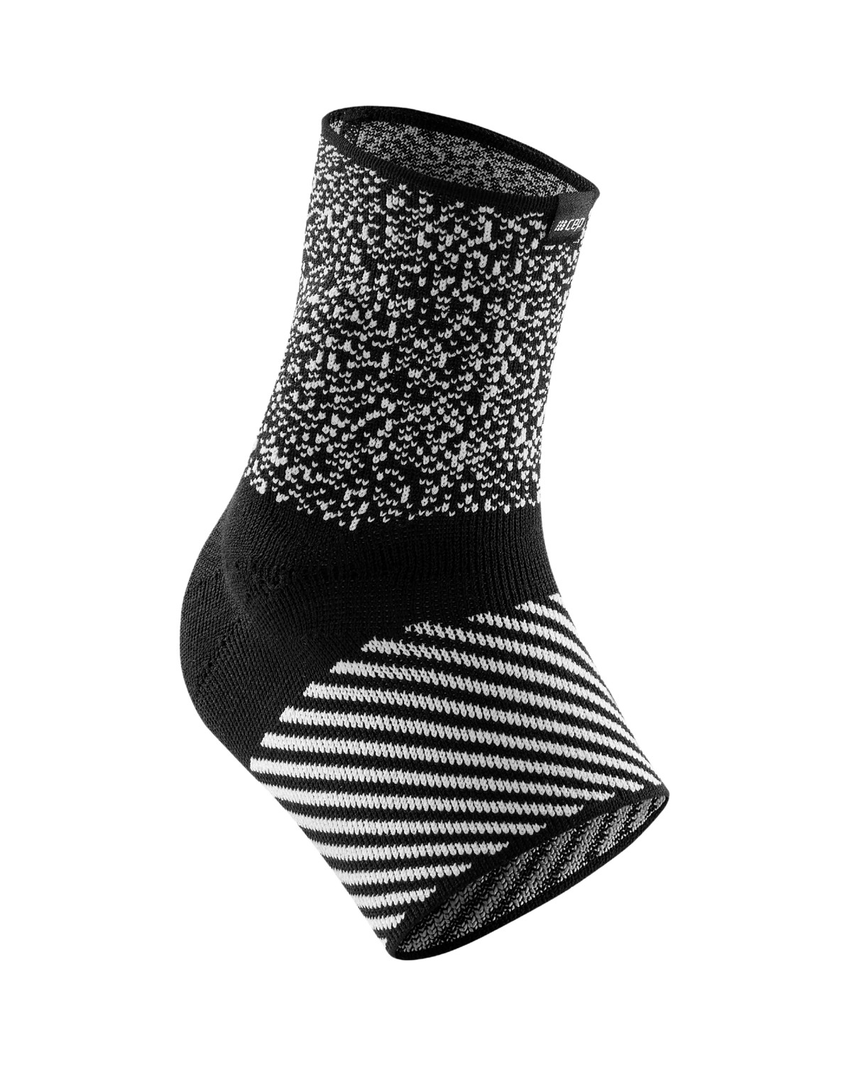 Ankle sleeve in black and white knit fabric with speckled upper and diagonal stripe pattern on the foot wrap area