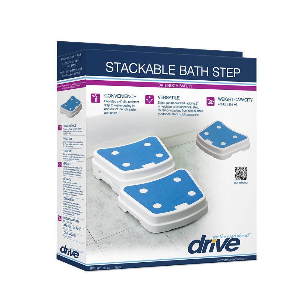 Portable bath step in white retail box showing stacked white steps with blue non-slip surface pads on a tiled bathroom floor
