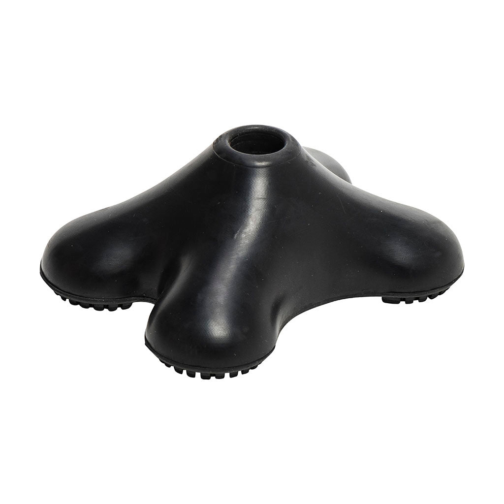 Quad cane tip in black rubber with four lobed base and center hole, featuring textured non-slip pads on each foot