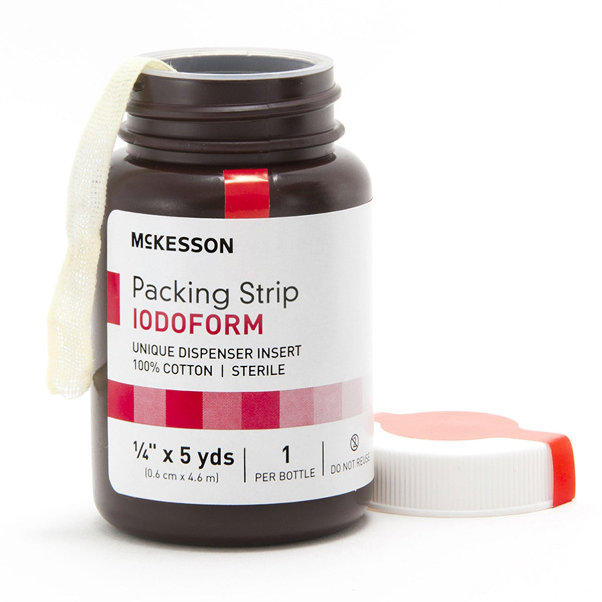 Iodoform wound packing strip in open dark amber dispenser bottle with cotton strip emerging from top, lid placed beside it