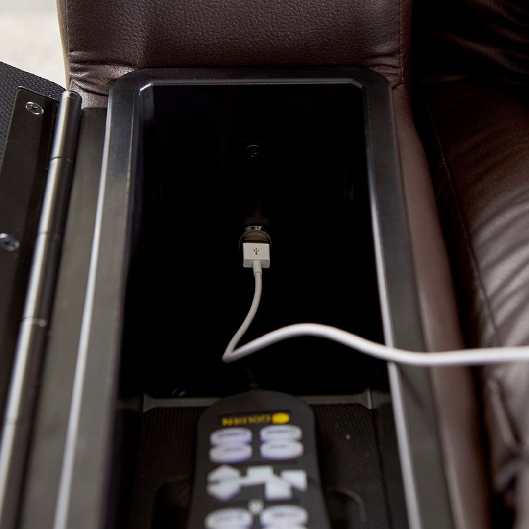 Lift chair armrest storage compartment open, showing built-in USB charging port with white cable and remote control inside