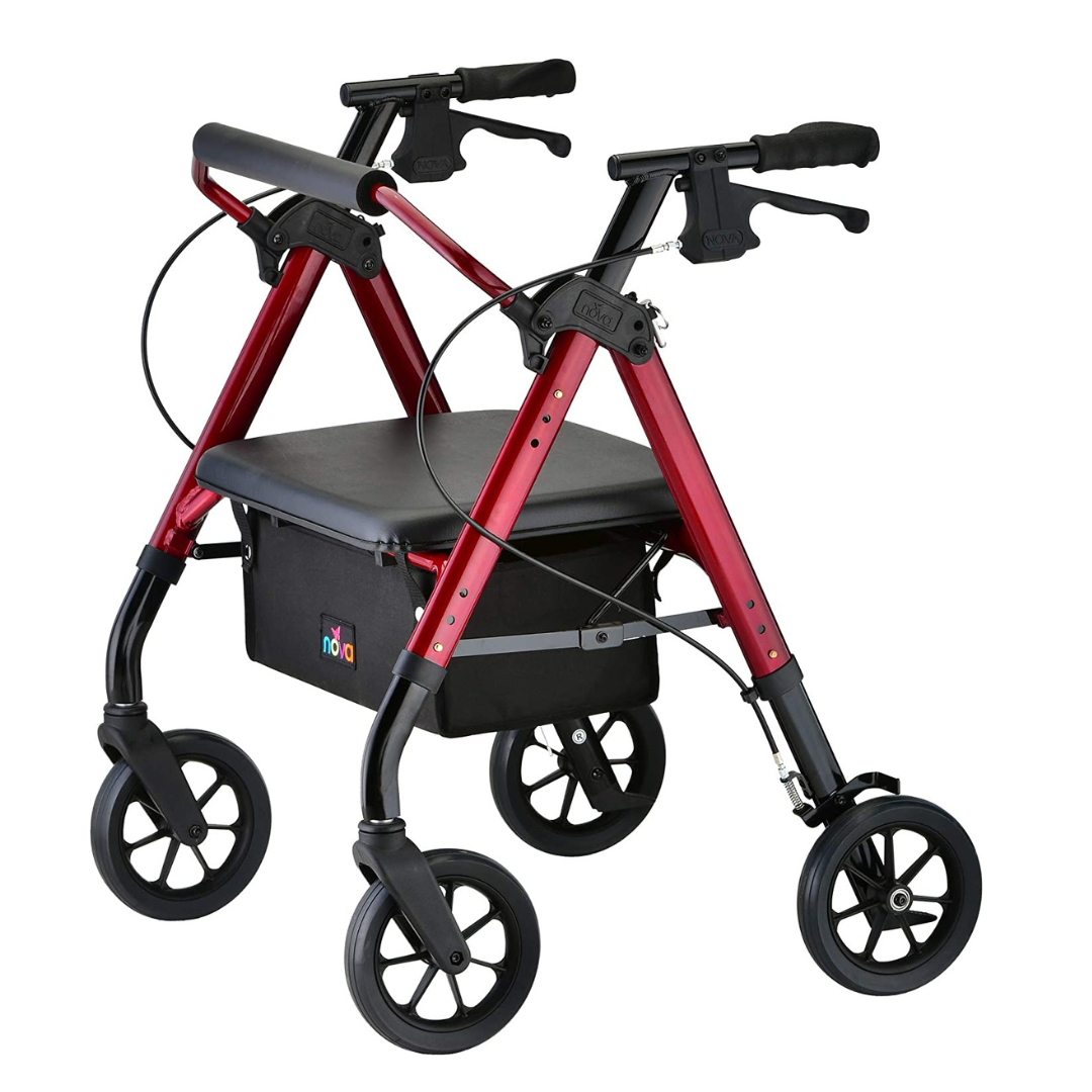 Rollator walker with red frame, black padded seat, under-seat bag, hand brakes, and large black wheels