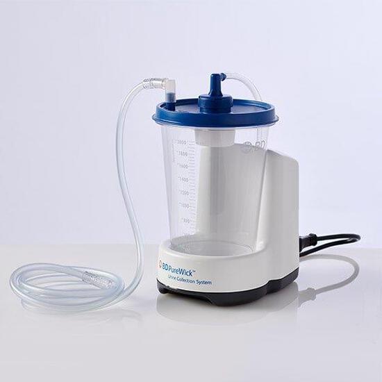 PureWick urine collection system with clear graduated canister, blue lid, white base unit, and flexible tubing