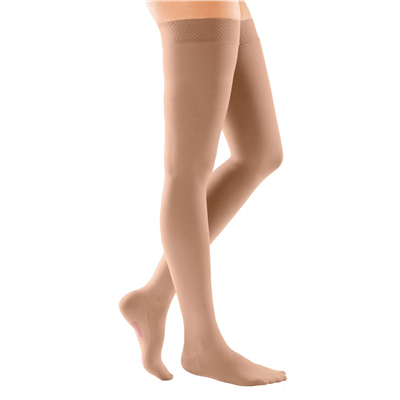 Thigh-high compression stockings with silicone top band in beige, shown on legs with closed toe and sheer finish