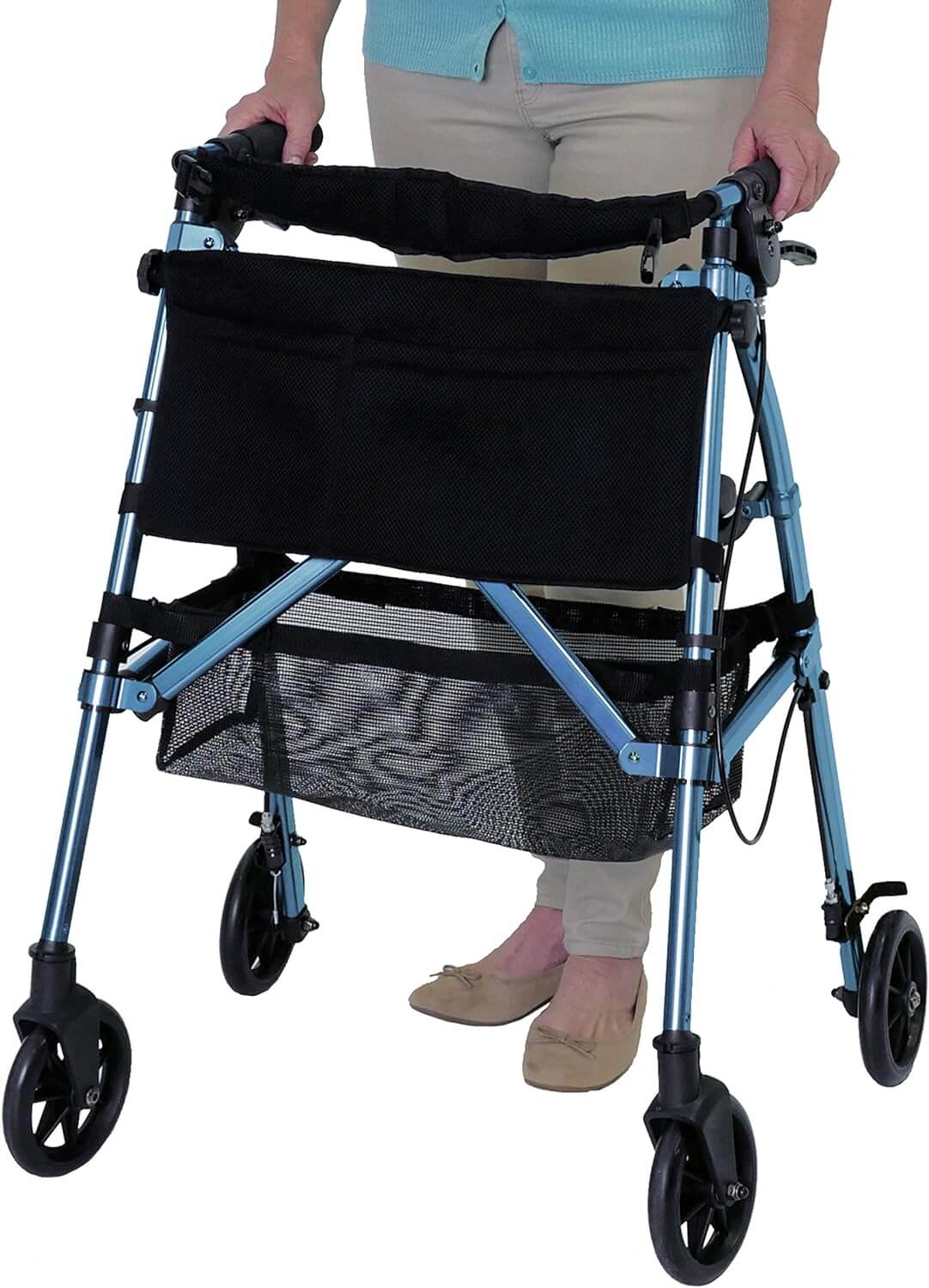 Rollator walker in blue with black mesh storage bag and lower basket, hand brakes, and four wheels, used by a woman