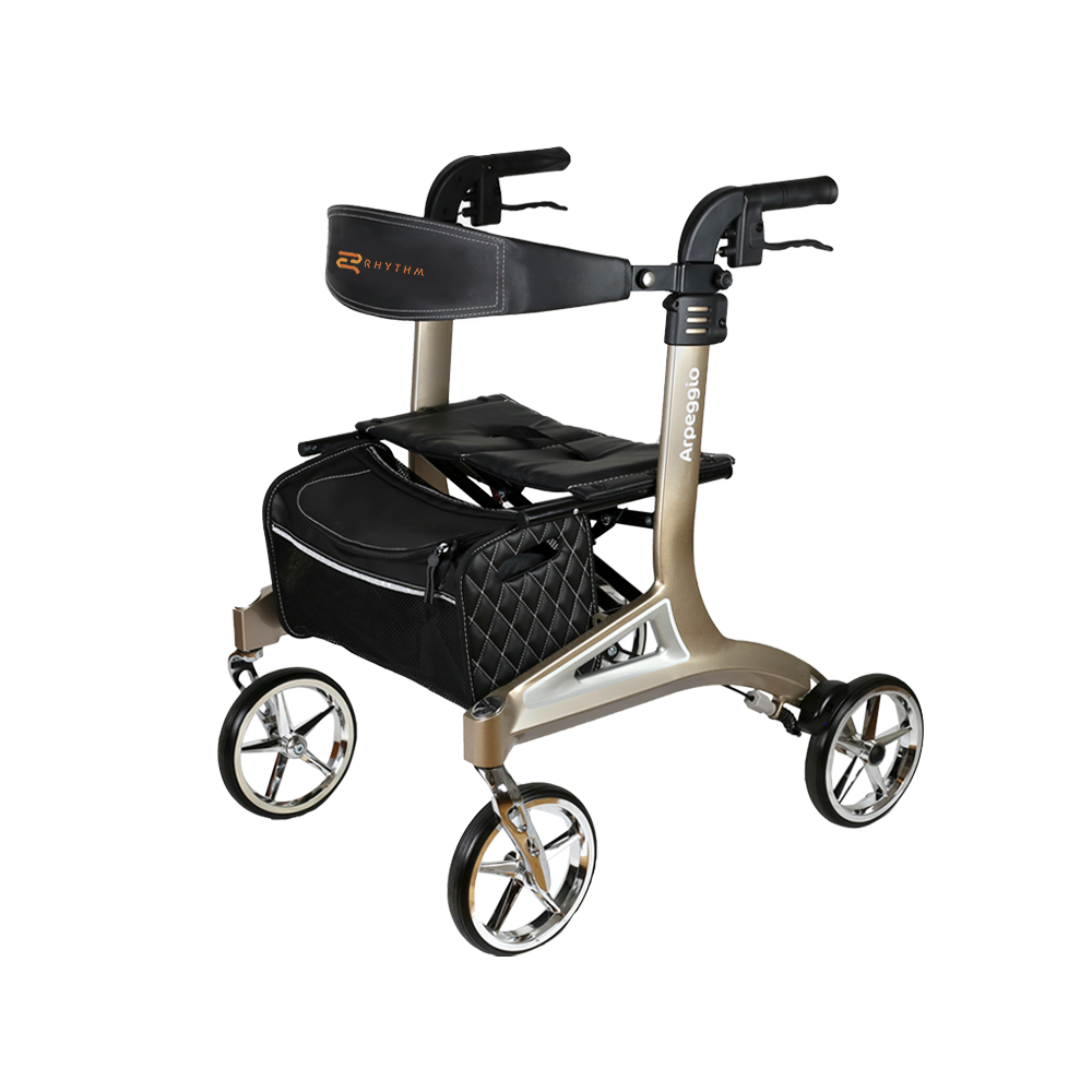 Rollator walker in champagne gold with padded seat, backrest, hand brakes, quilted storage bag, and chrome-spoke wheels