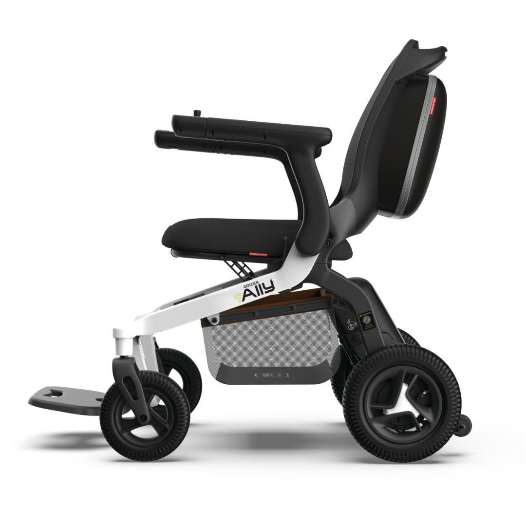 Golden Ally folding power wheelchair shown from the side, featuring a white frame, black upholstery, padded armrests, and