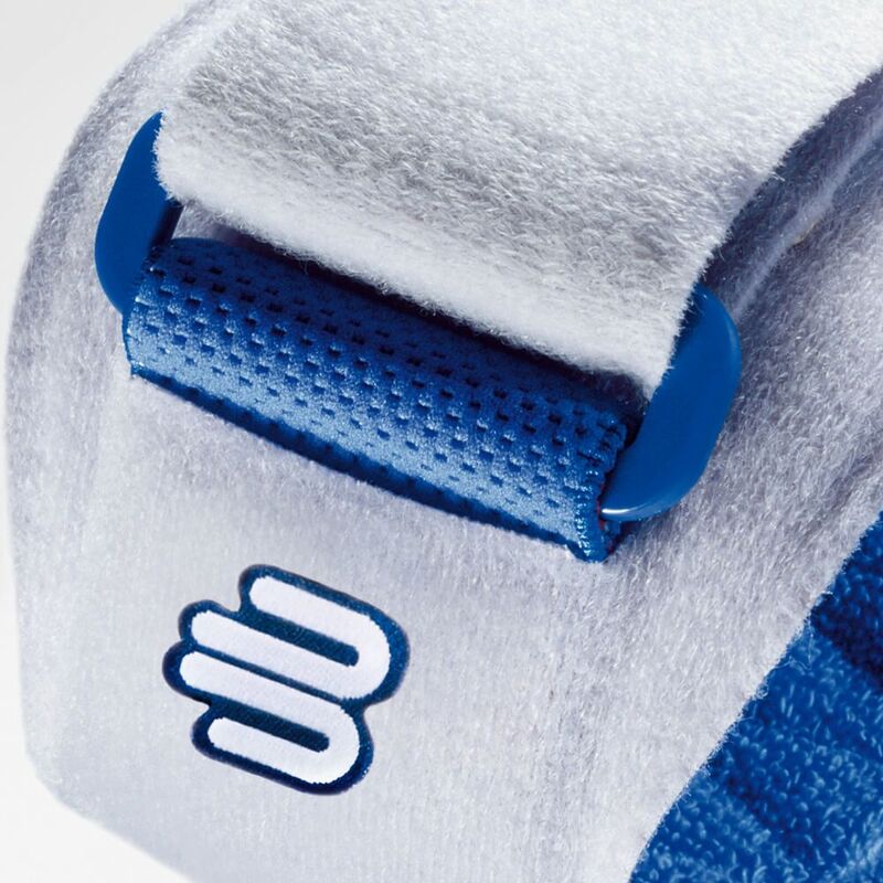 Elbow strap close-up showing white terry fabric, blue hook-and-loop closure, perforated pressure pad, and embroidered logo