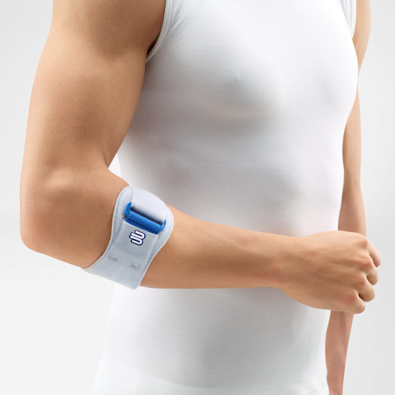 Elbow strap with blue pressure pad worn just below the elbow on a person in a white sleeveless shirt