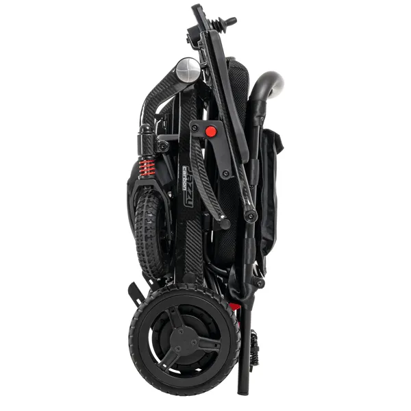 Jazzy Carbon portable power chair folded flat, showing black carbon fiber frame, red accents, and rear wheels