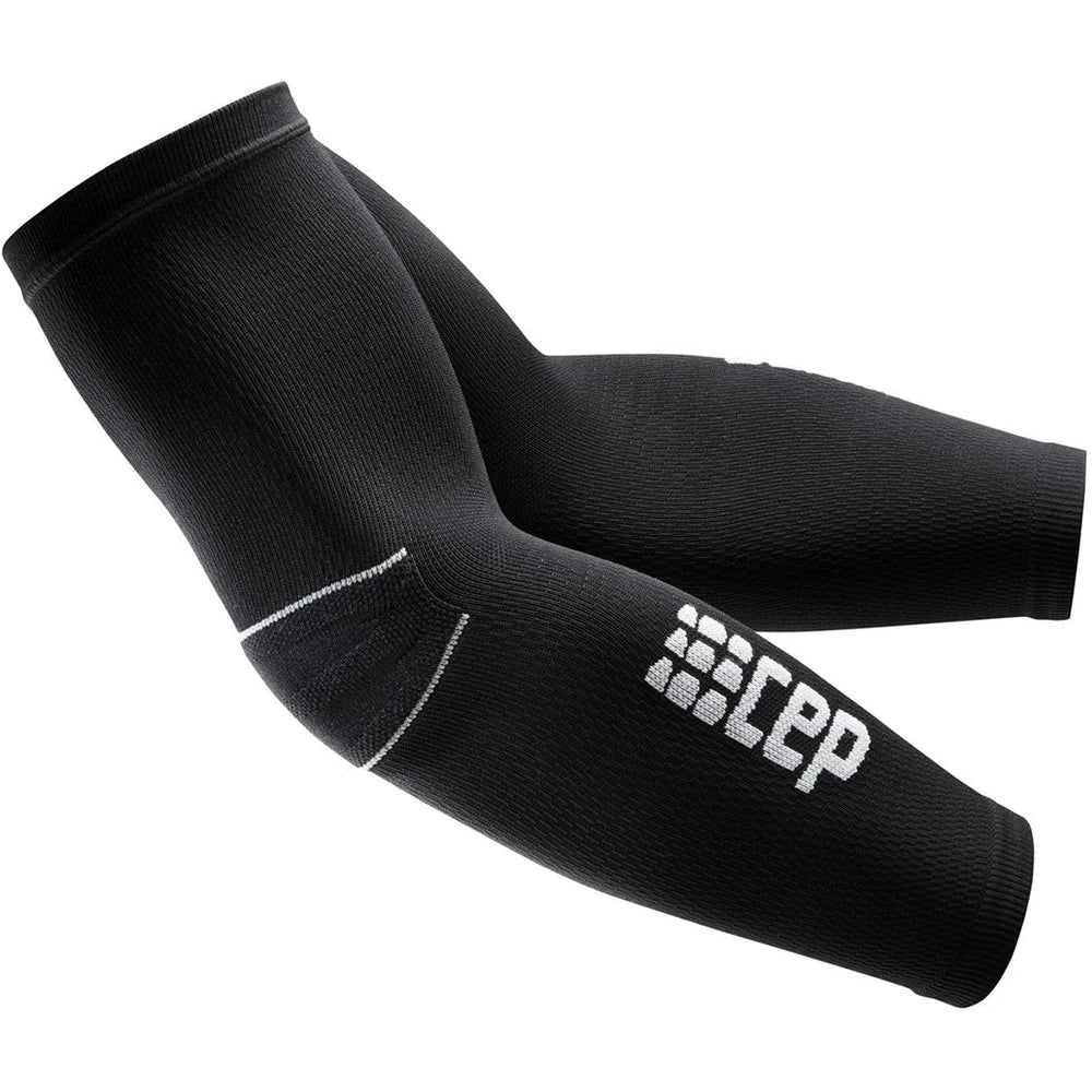 CEP compression arm sleeves in black with white logo, shown as a pair covering elbow to upper arm on white background