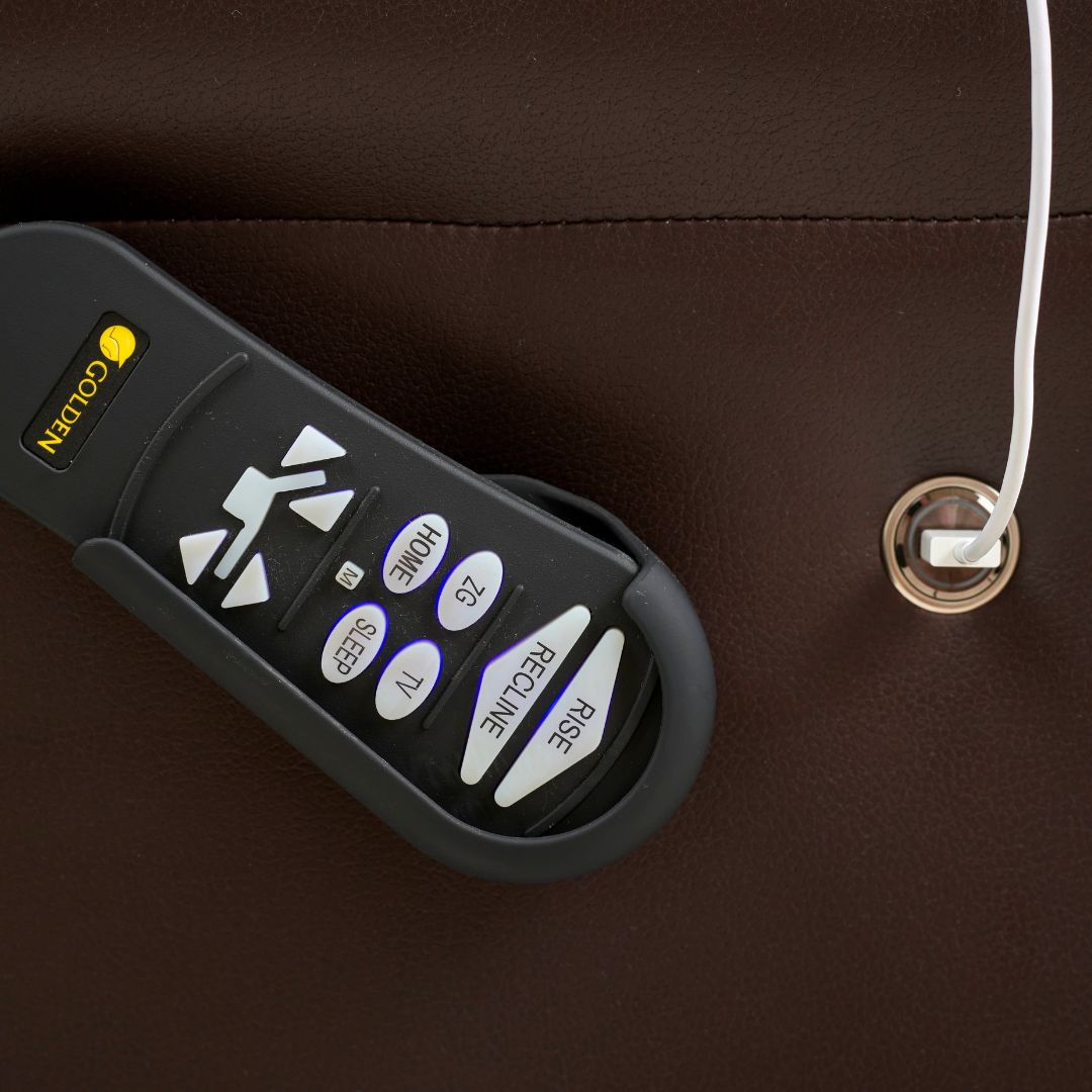 Lift chair remote control with recline, rise, sleep, TV, home, and zero-gravity buttons, resting in brown leather side pocket