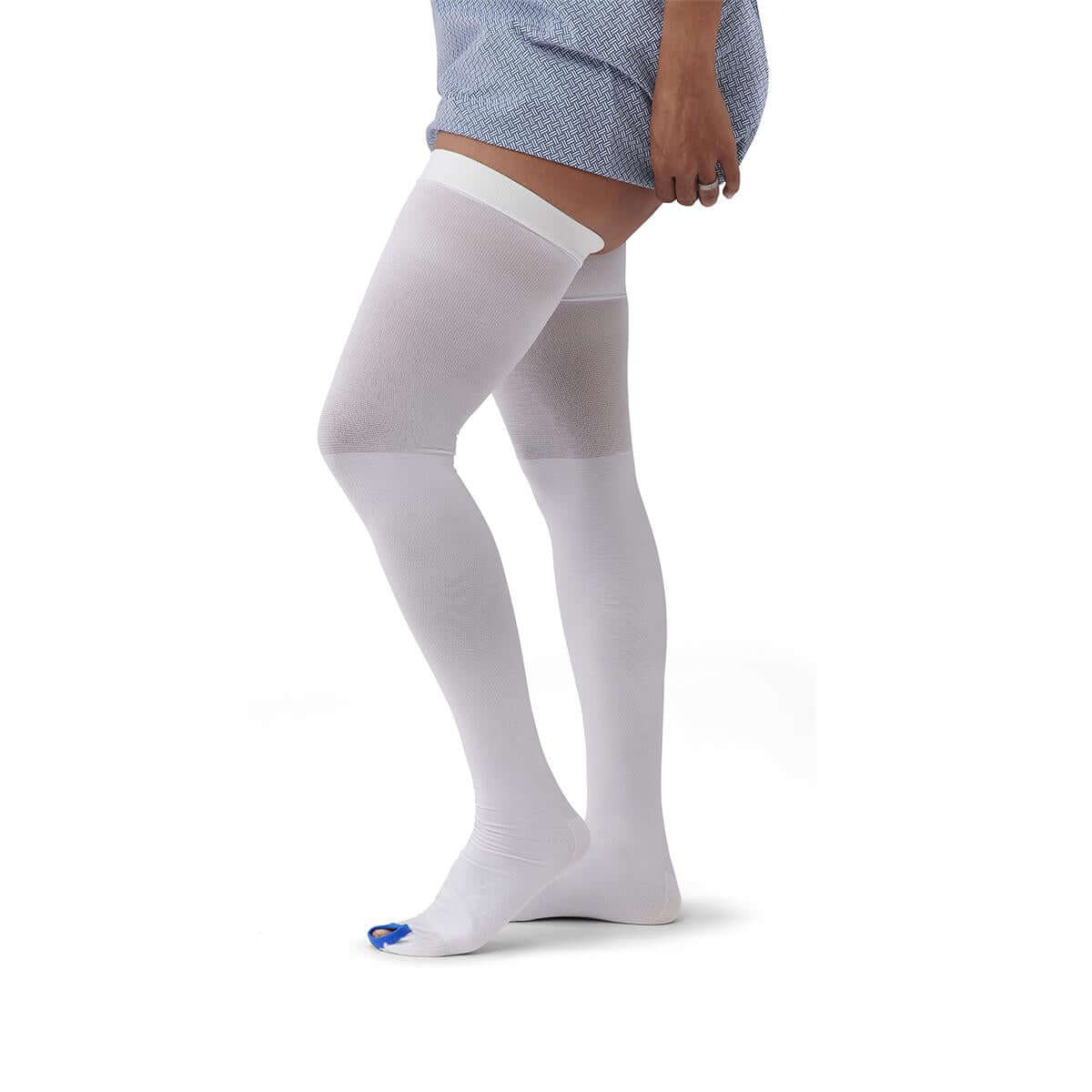 Thigh-length anti-embolism stockings in white with open toe in blue, shown on a person's legs, thigh-high length