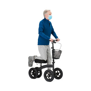 All-terrain knee walker used by masked older man in blue shirt, with padded knee rest, basket, and four large wheels