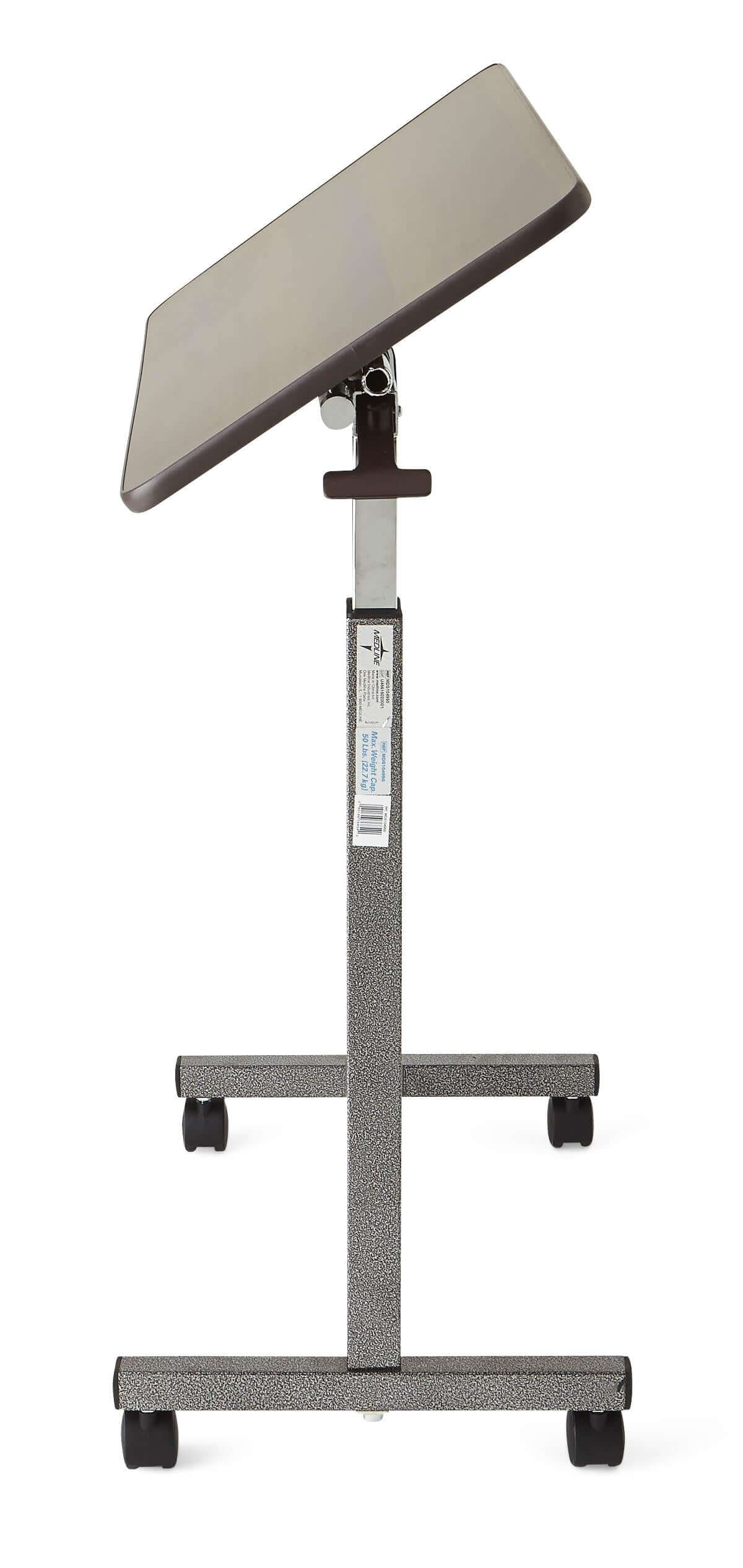 Tilt-top overbed table with angled walnut-finish surface, height-adjustable chrome post, and four-wheeled rolling base
