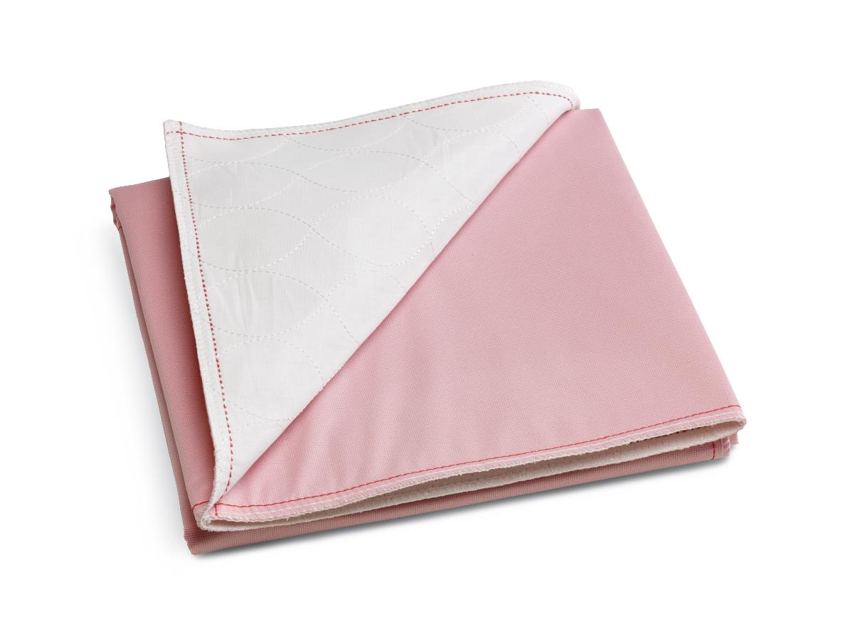 Reusable underpad folded to show pink fabric top and white quilted underside with red stitching