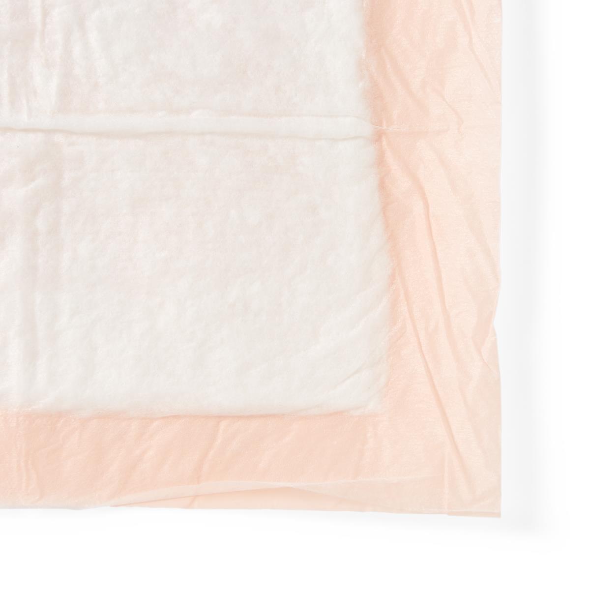 Disposable underpad with white absorbent top layer and peach waterproof backing, shown flat on white background