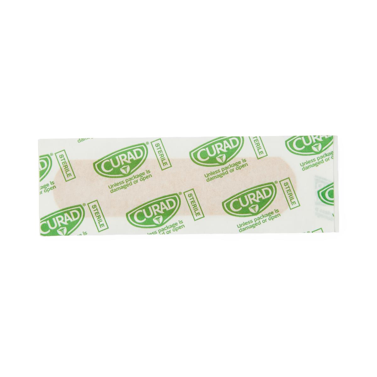 Plastic adhesive bandage in sealed Curad sterile wrapper, shown on white background