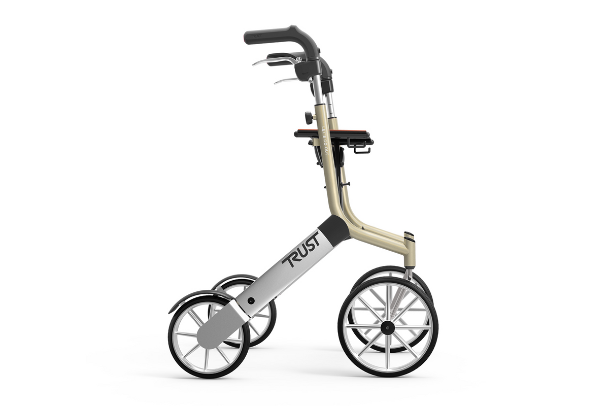 Rollator walker with large spoked wheels, hand brakes, padded seat, and champagne-colored frame, shown from the side