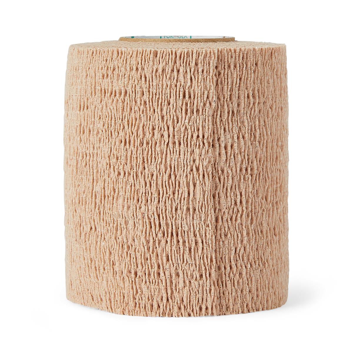 Cohesive bandage roll in beige with textured self-adherent surface, shown upright on white background