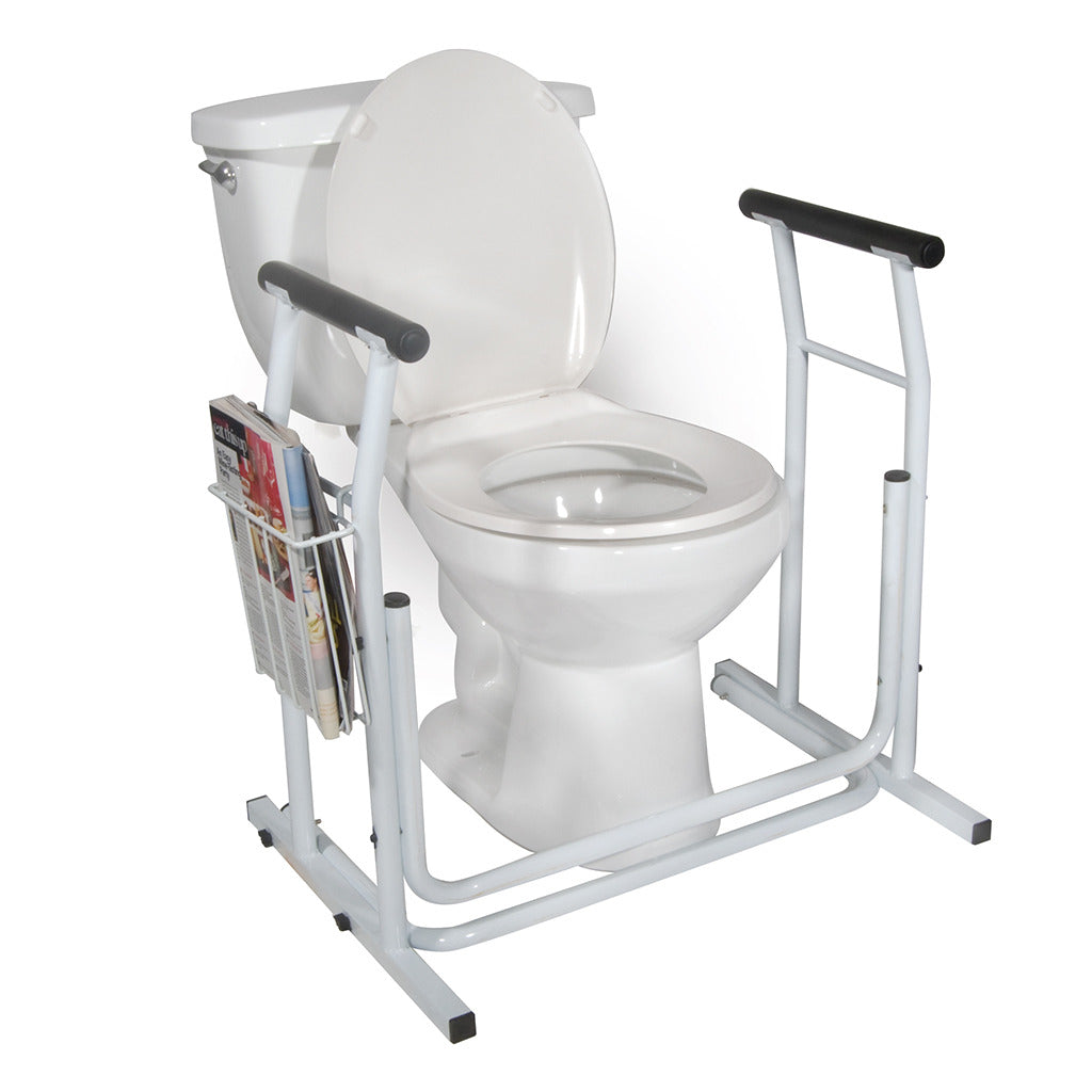 Stand alone toilet safety rail with padded armrests and side magazine rack, shown installed around a white toilet
