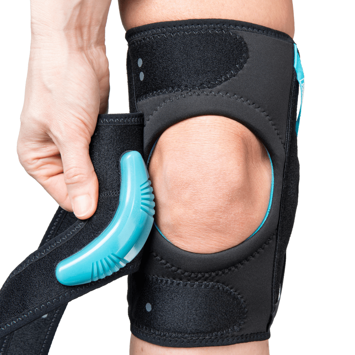 Knee brace with open patella design and teal J-shaped buttress being adjusted by hand, shown worn on a knee