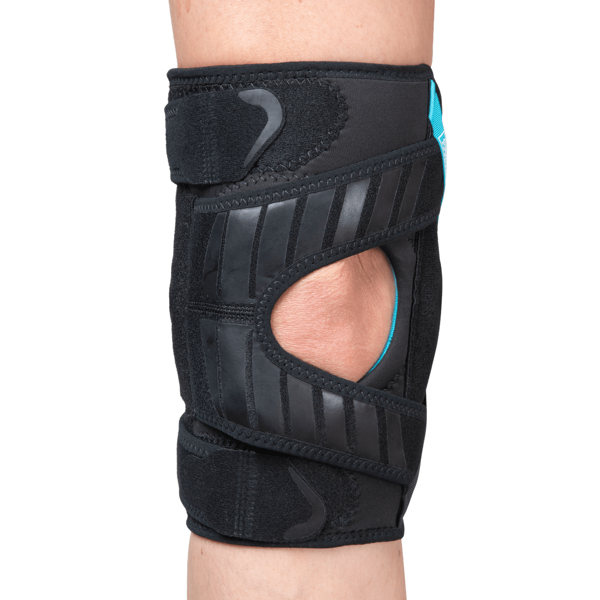 Knee brace with open patella cutout, black neoprene wrap, teal accents, and diagonal rubber reinforcement strips worn on leg