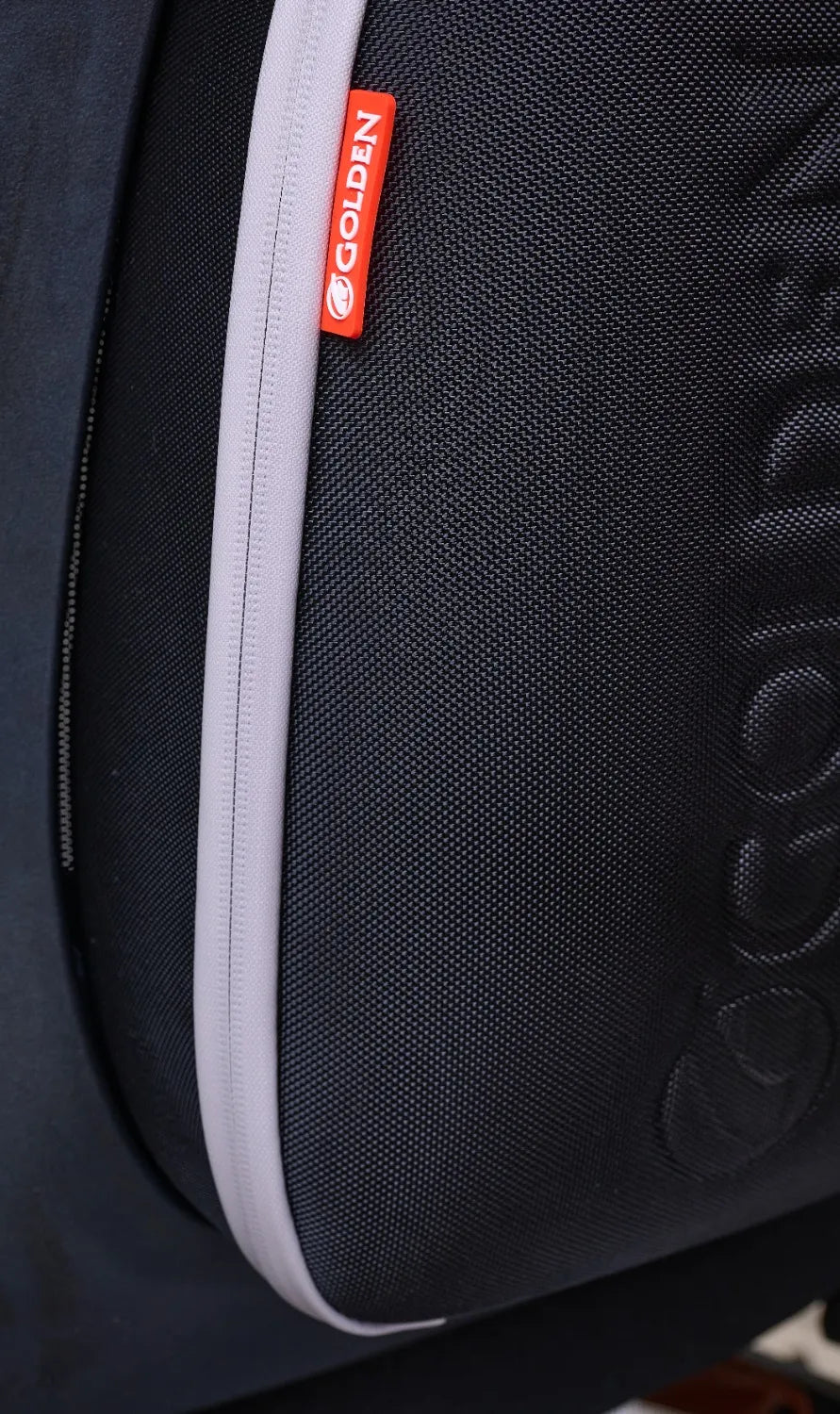 Power chair travel bag in black nylon with gray zipper trim and red Golden Technologies brand tag, close-up view