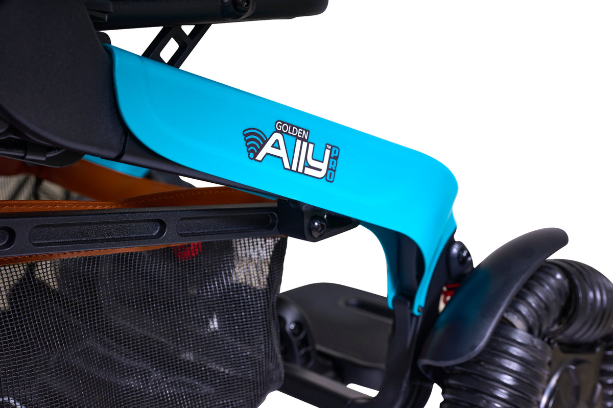 Power chair side panel in bright teal showing Golden Ally Pro logo, with under-seat mesh basket and black rear wheel visible
