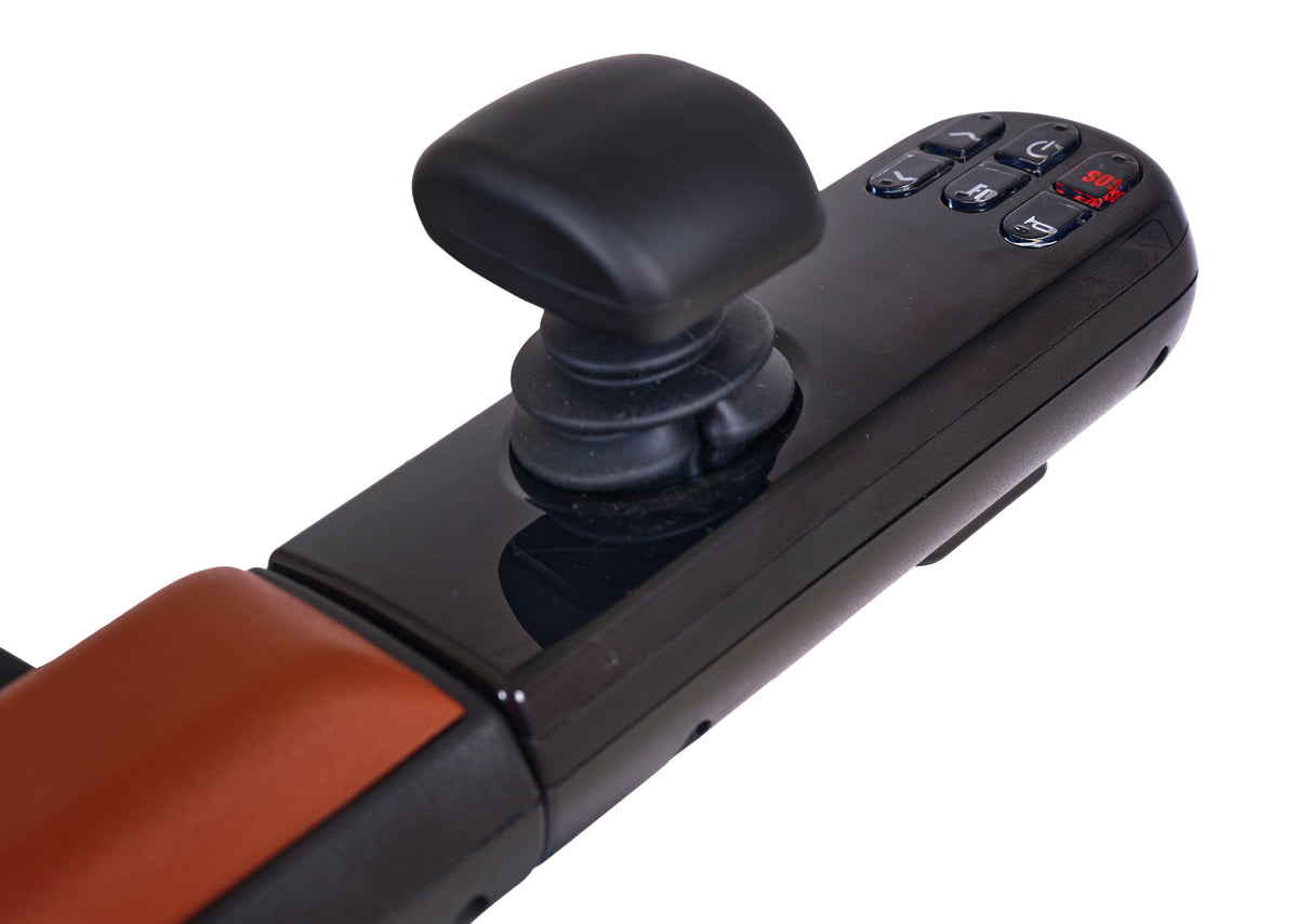 Power wheelchair joystick controller with black joystick handle, directional buttons, and red LED display on orange armrest