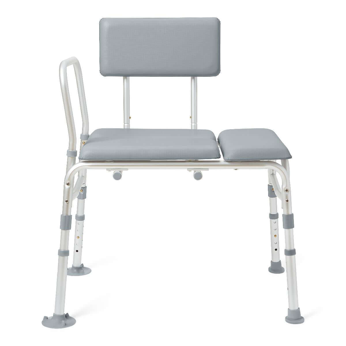 Padded transfer bench with white aluminum frame, gray cushioned seat and back, one armrest, and adjustable legs with suction