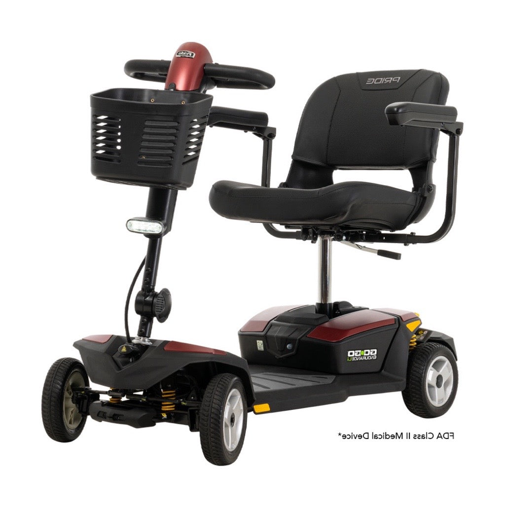 4-wheel power mobility scooter in red and black with padded captain's seat, armrests, front basket, and headlight