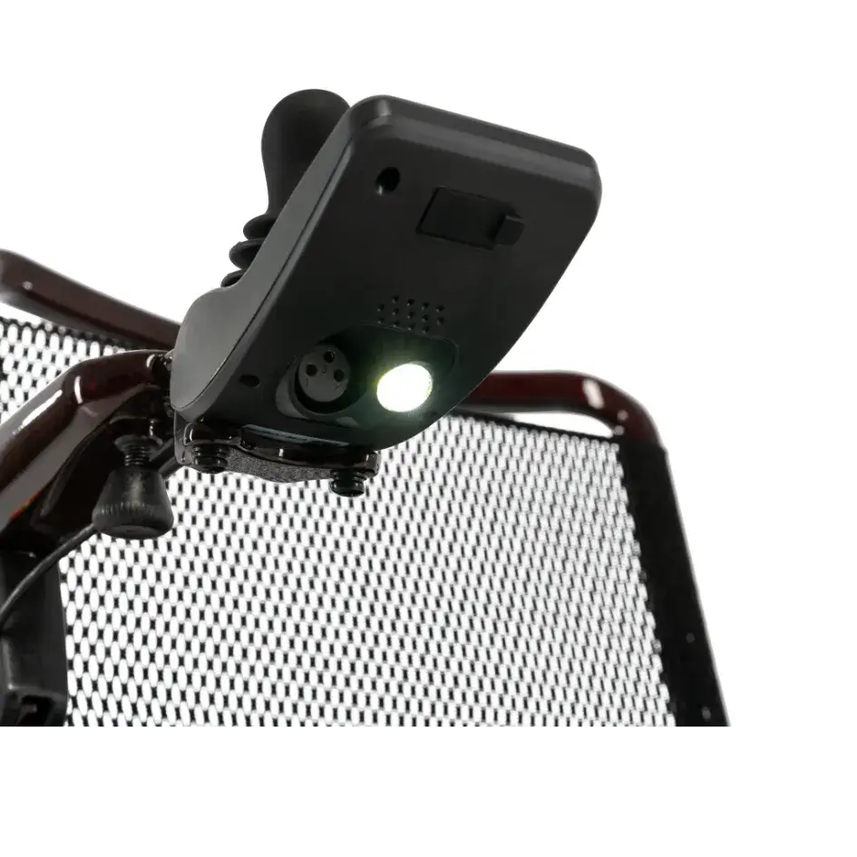 Power wheelchair LED light accessory clipped onto the mesh back frame of a black and burgundy power wheelchair