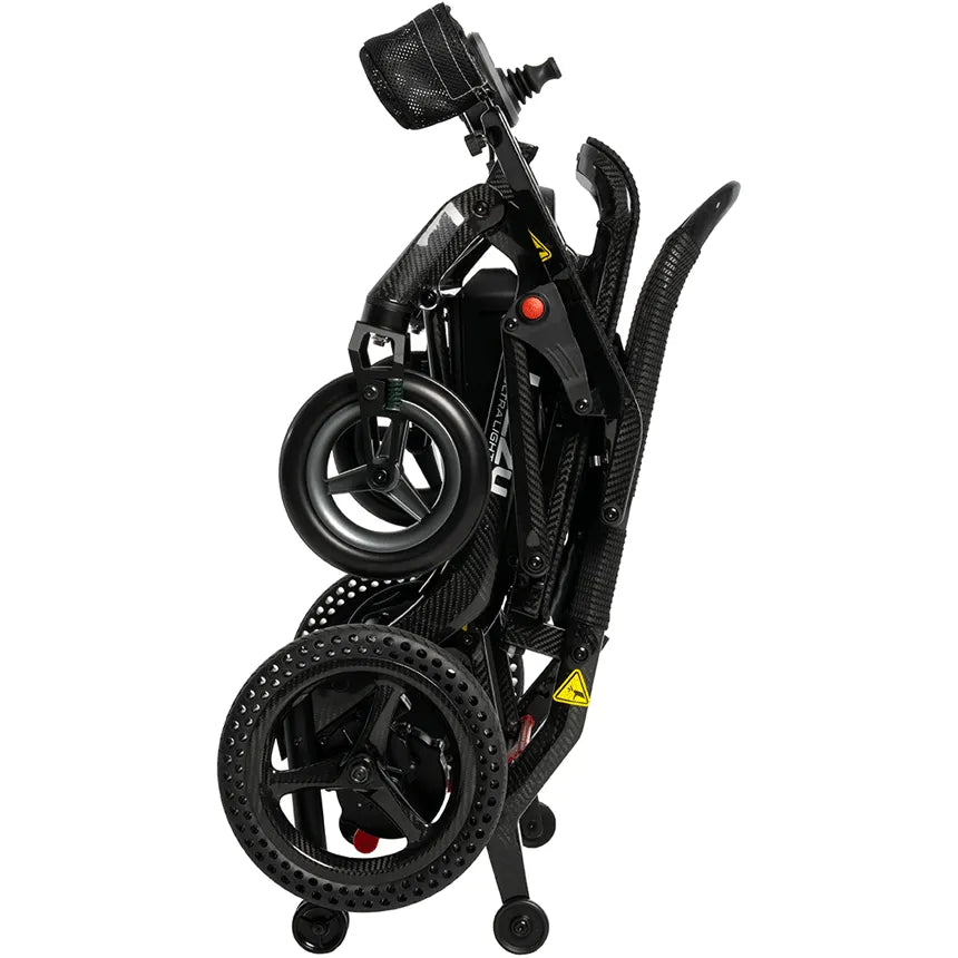 Jazzy Ultra Light folding power wheelchair collapsed into compact folded position, showing carbon fiber frame, joystick, and