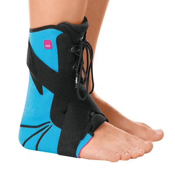Ankle brace in blue and black with lace-up closure and wraparound straps, worn on a left foot and ankle
