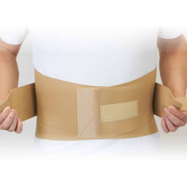 Lumbar sacral support belt in beige worn around a person's lower back, shown from the front with hook-and-loop closure panels
