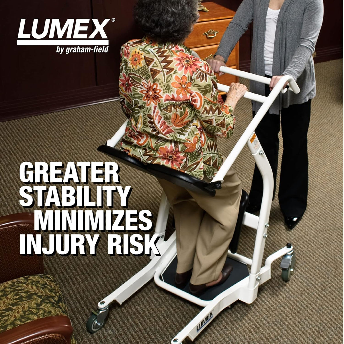 Lumex stand assist patient lift with elderly woman being helped to stand by caregiver, white steel frame with casters and
