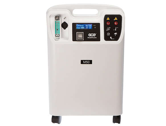 Stationary oxygen concentrator with digital display, flow meter, control panel, and wheeled base, front view on white