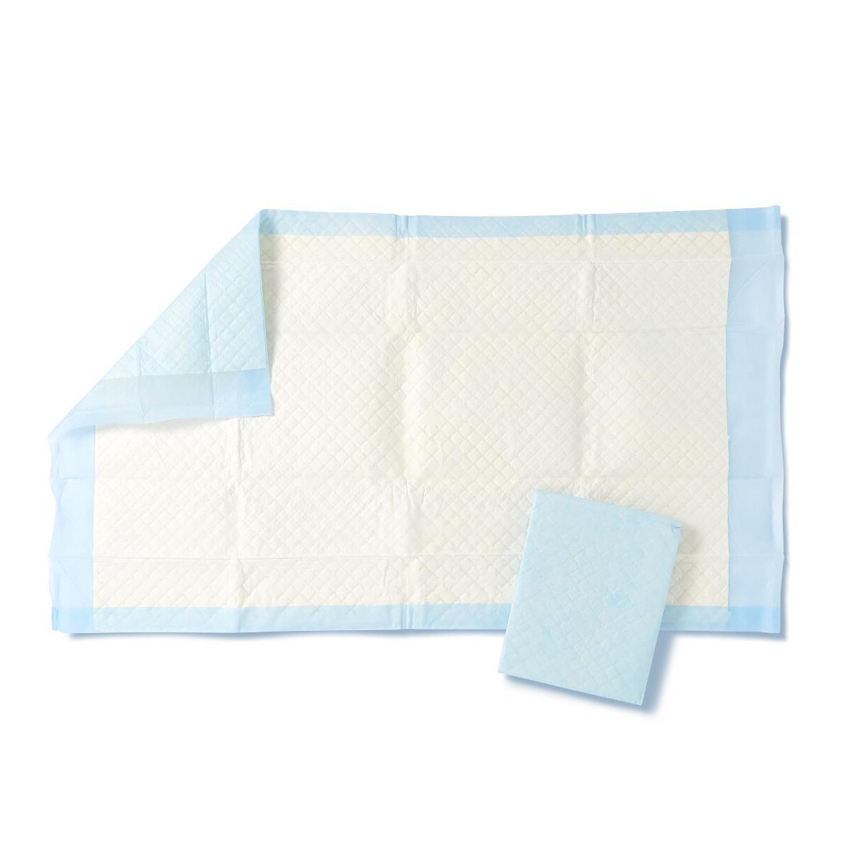 Disposable underpads with white quilted top surface and light blue border, shown unfolded and folded on white background